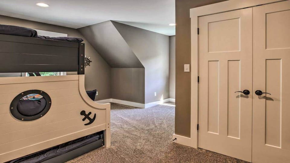 Awesome ship themed kids room on 2nd level with bunk beds that have a port hole!