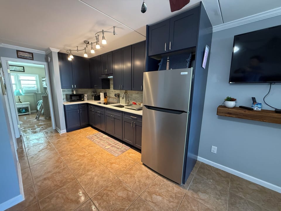 Upgraded kitchen with nice  countertop and full-size refrigerator