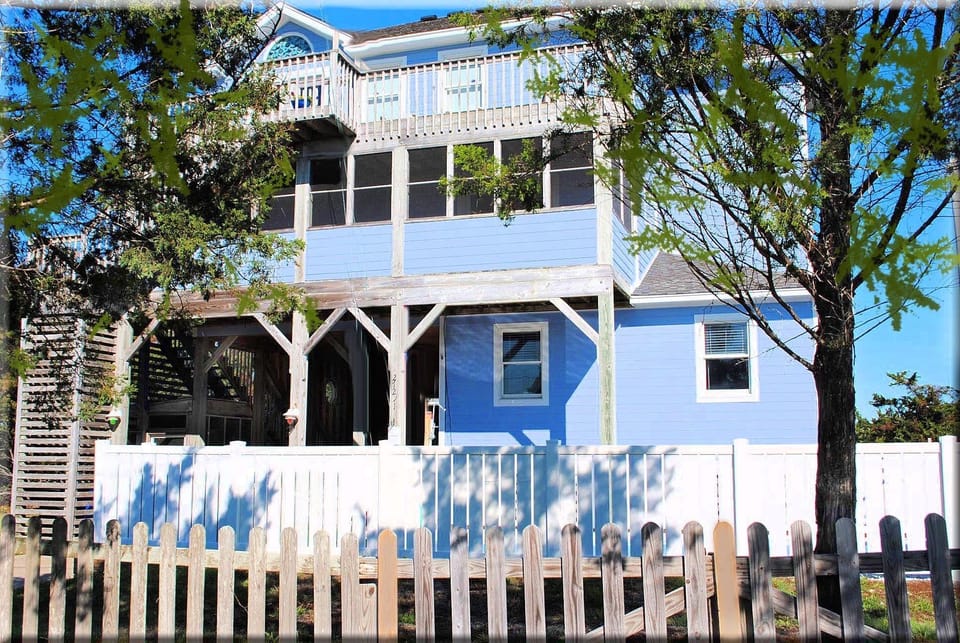 Front of the house, white fence is around the pool and hot tub.
