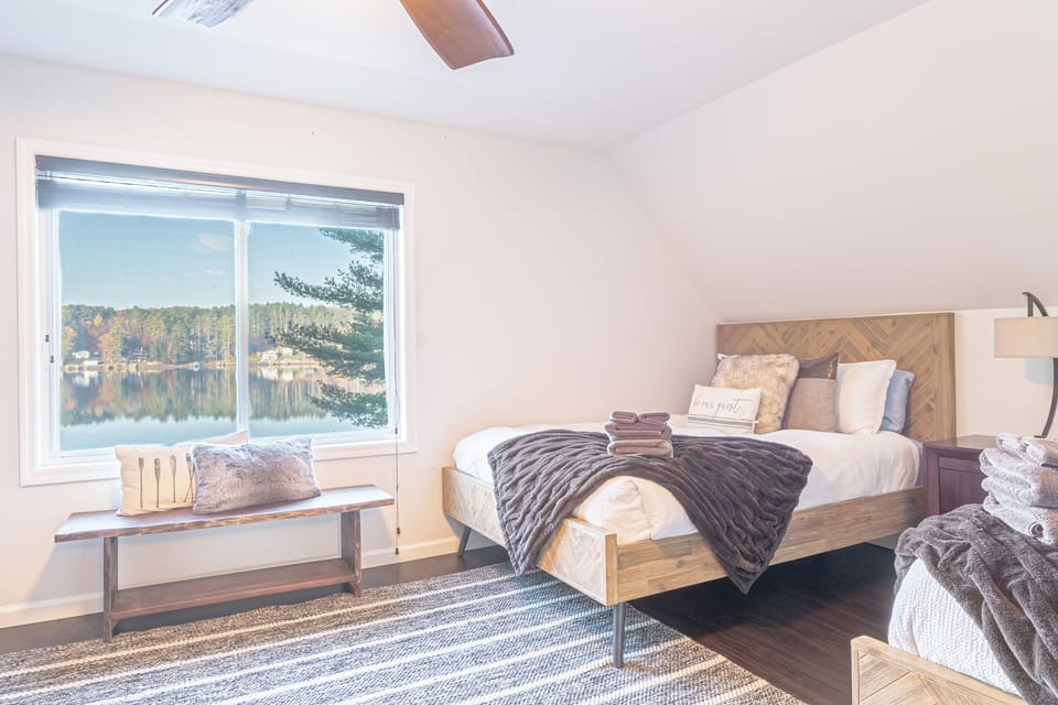 Third-level Queen Bedroom with 3 queen beds, electric fireplace and lake views