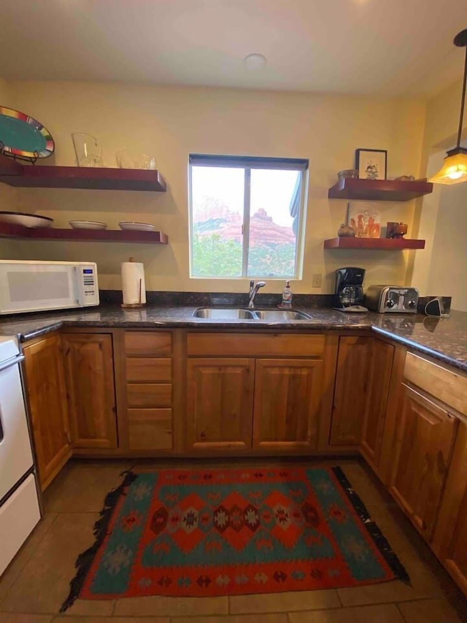 Large kitchen with views and bar seating to right (not shown).