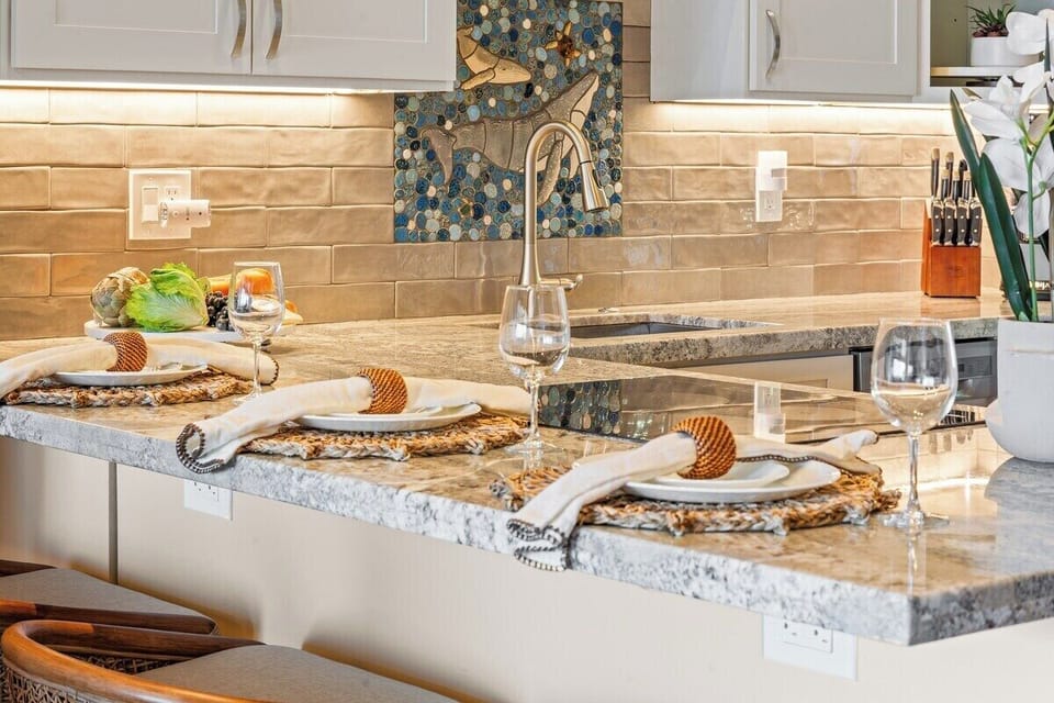 Granite kitchen island with induction cooktop, perfect for cooking and gathering.