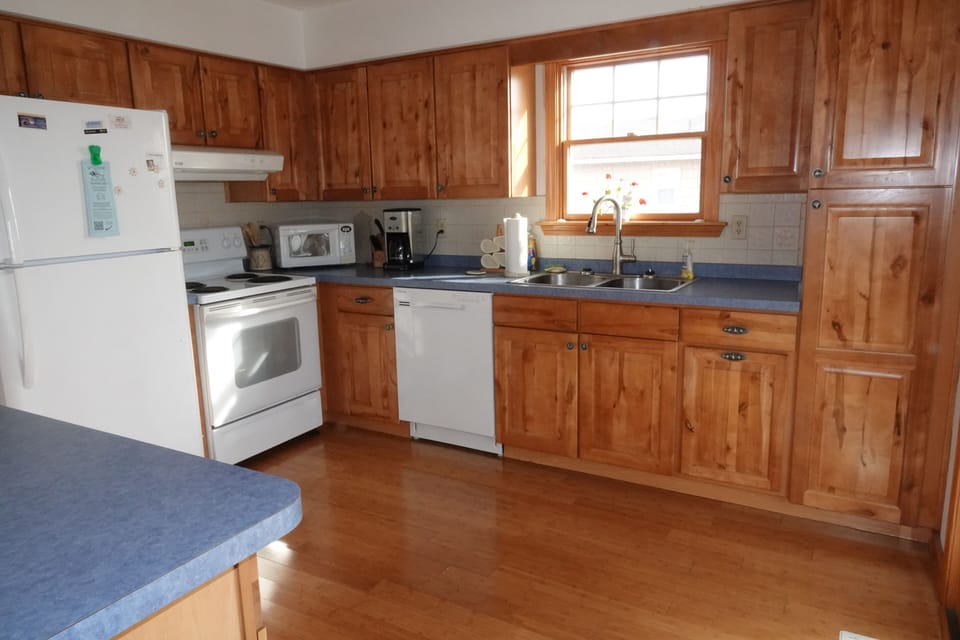 The well stocked kitchen is open to the living and dining areas.