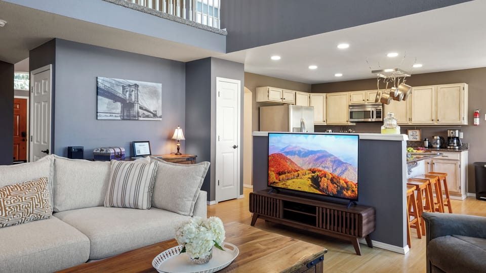 Living room with smart TV & cable access.