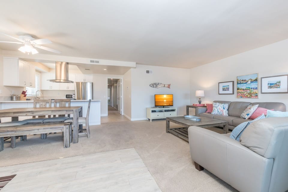 Vantage point from the unit's entry area toward living room and TV. Carpeting throughout this upper unit.
                