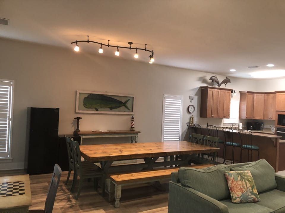 Custom dining room table has seating for 12. Ten cubic foot fridge for drinks.