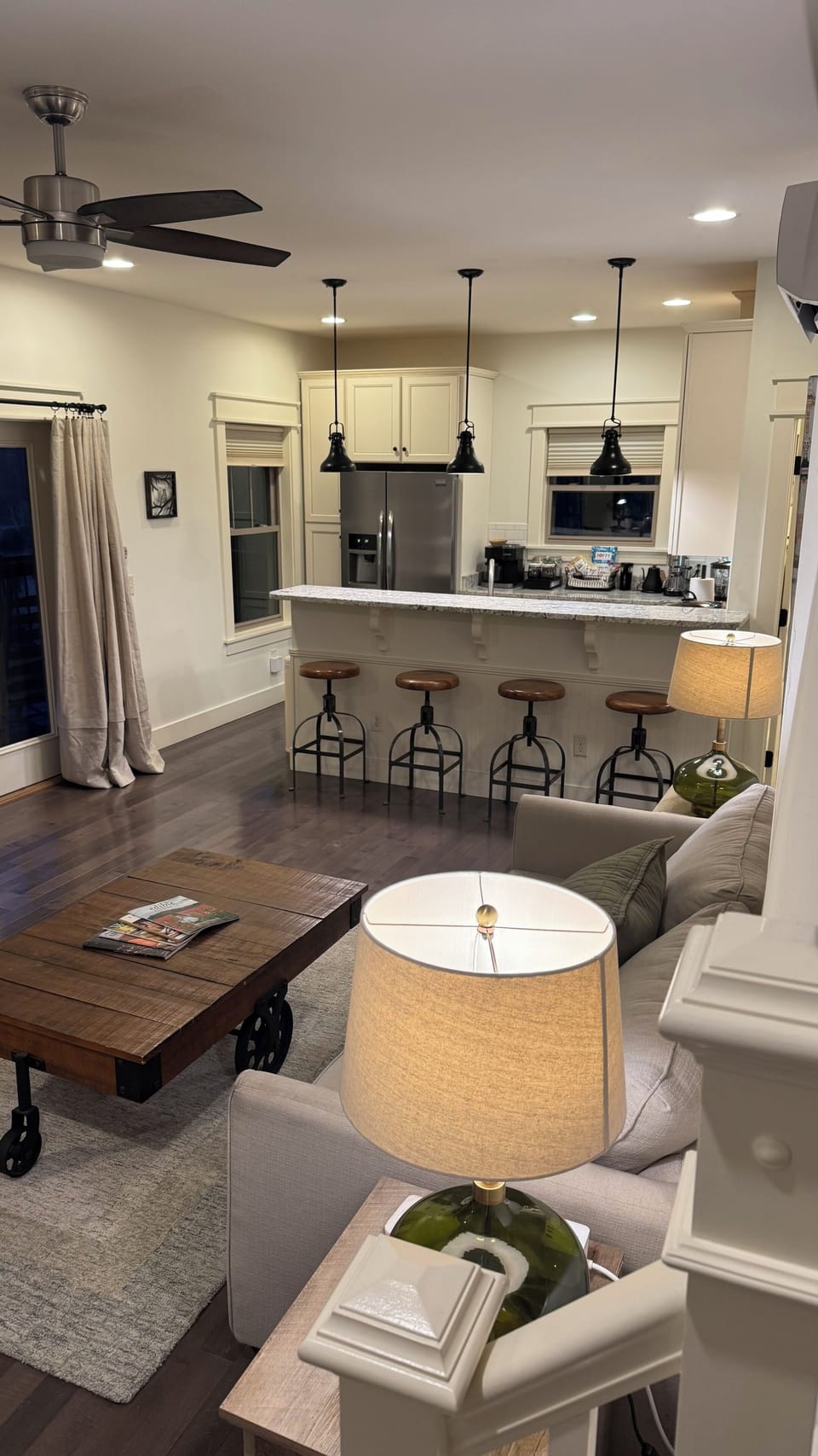 Main level living room, kitchen with bar.