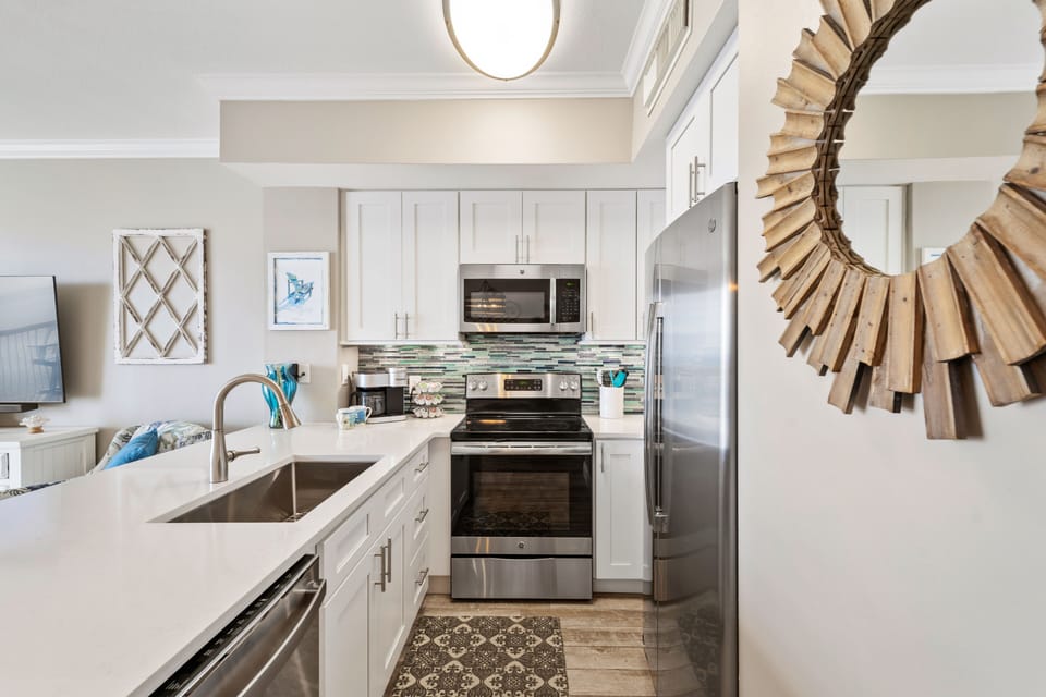 Quartz countertops, glass tile backsplash and LED undermount lighting