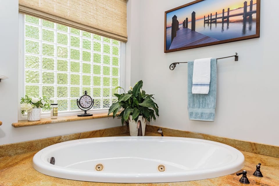 Main floor primary bathroom with soaking tub.