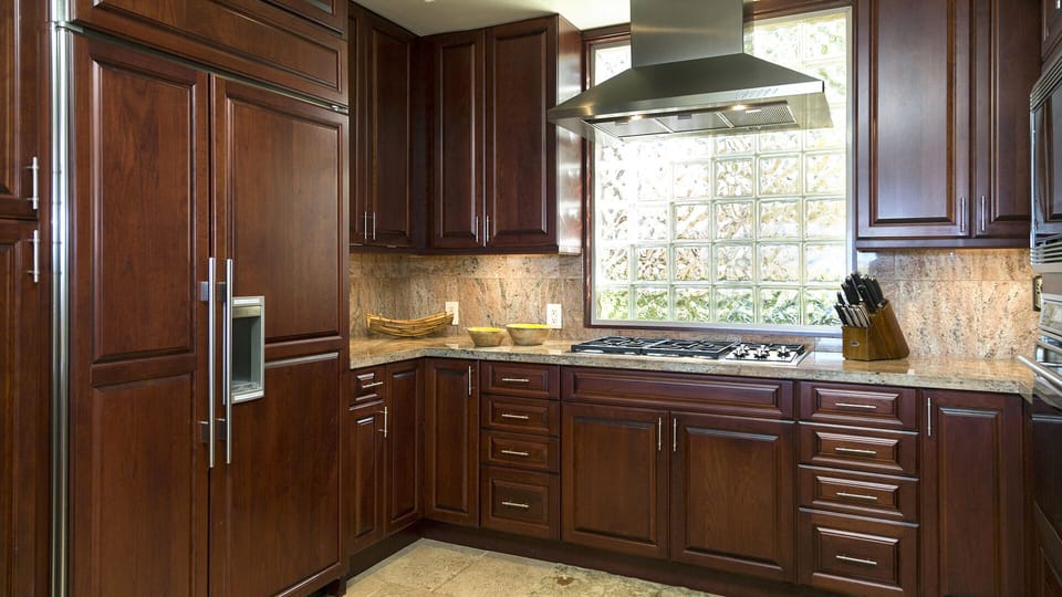 Mahogany paneled Sub Zero refrigerator, Wolf stove top, Fisher Paykel dishwasher
