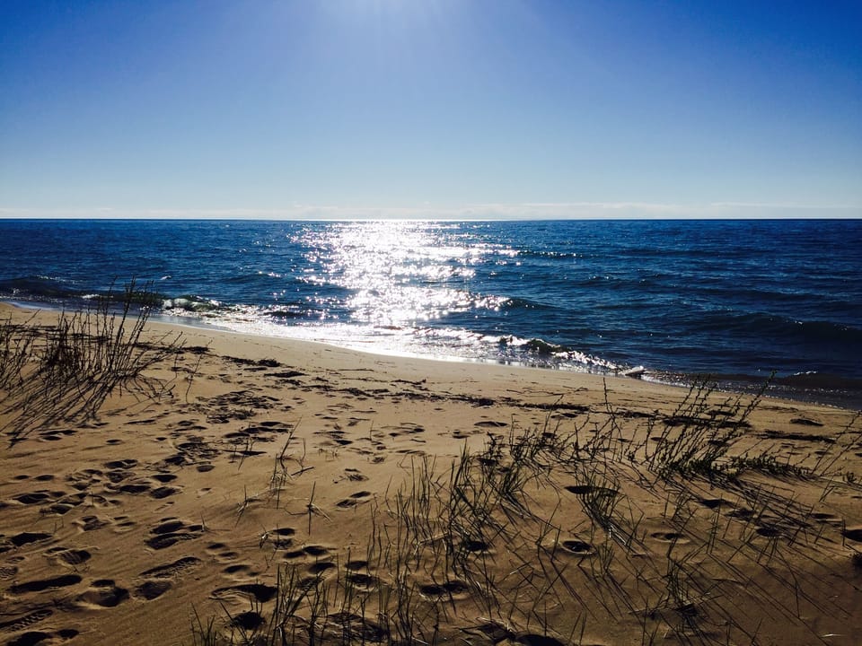 100+ feet of private sandy beach. Walk for miles north and south. 