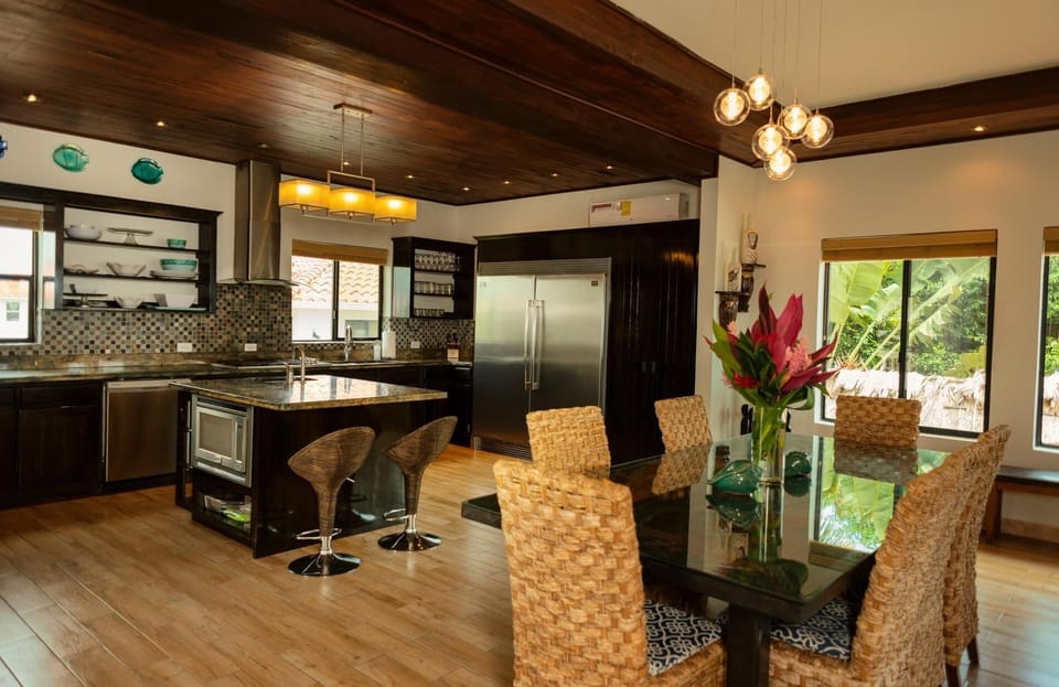 Kitchen, breakfast bar, and dining table.