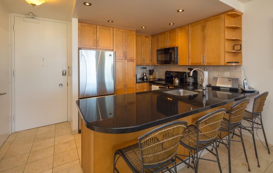 Seating for four at the black granite countertop.