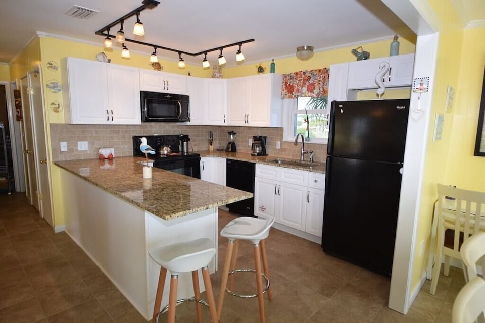 Spacious, fully stocket kitchen with granite counter tops