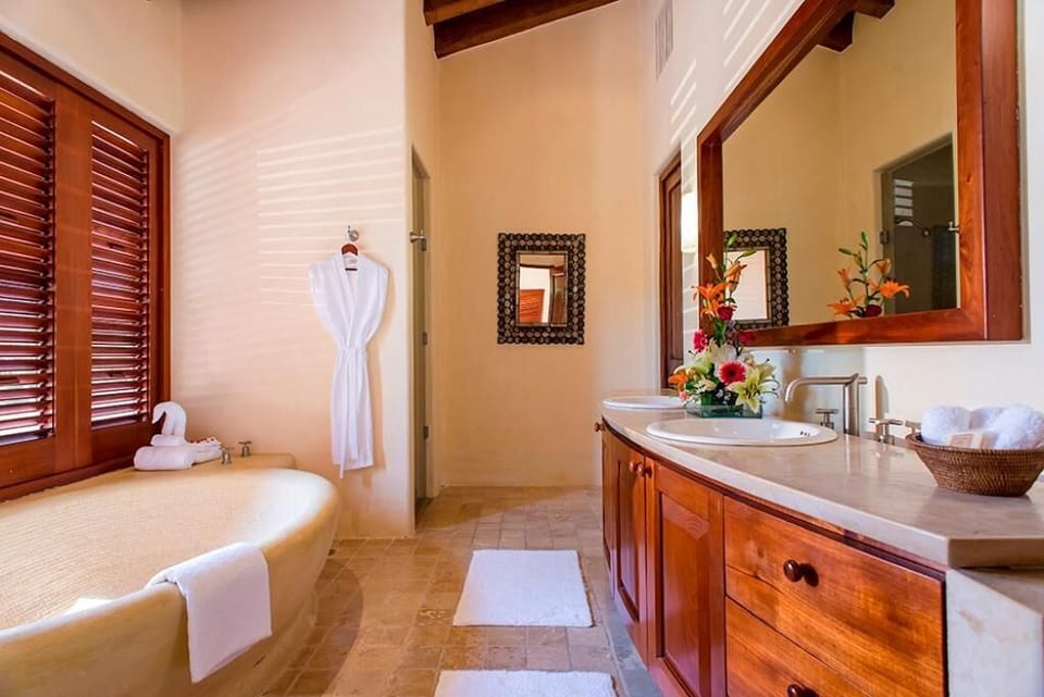 Enjoy this beautifully designed bathroom, featuring a large tub and plush amenities.