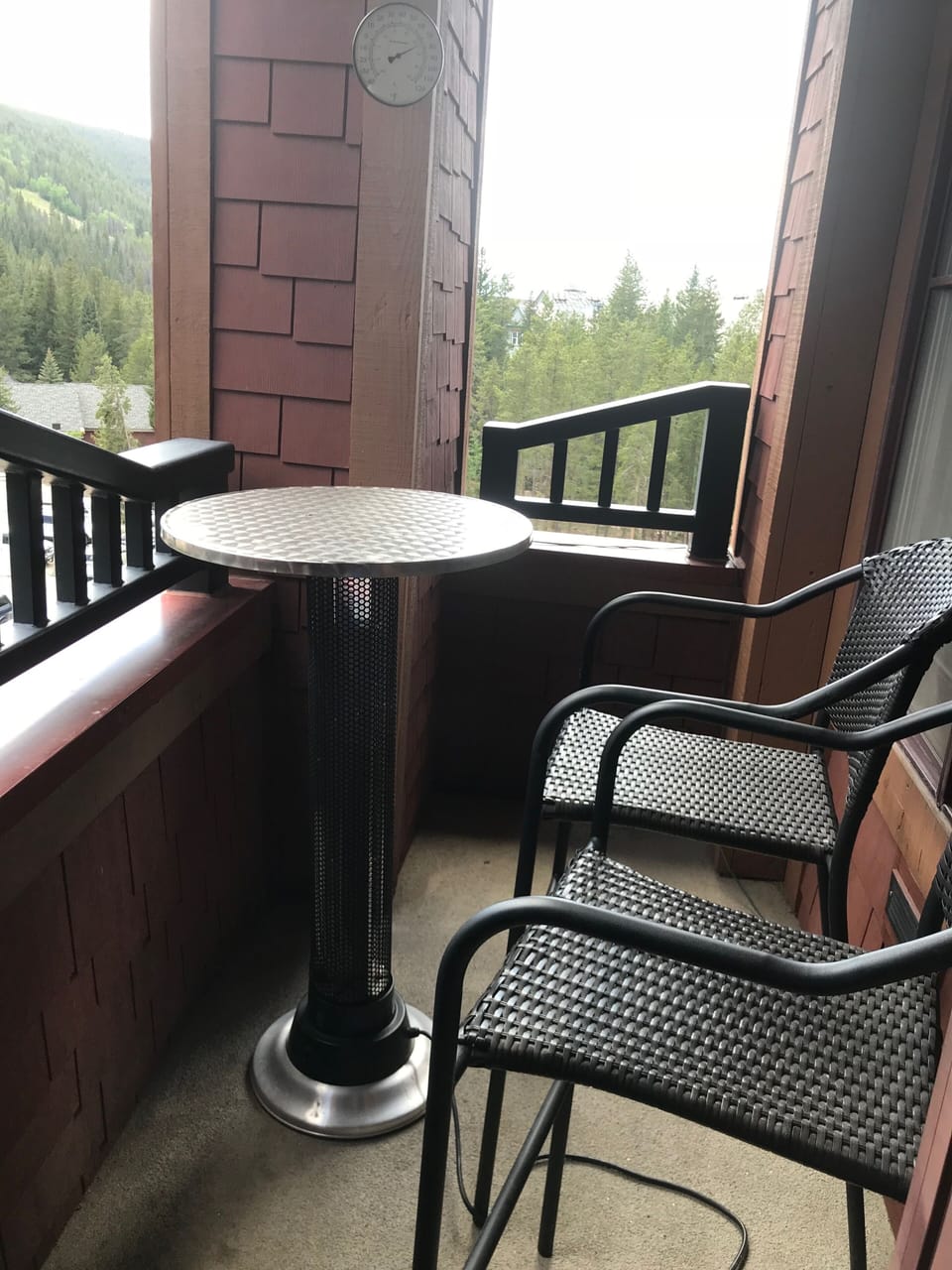 Balcony facing the mountain with seating for 2 and table