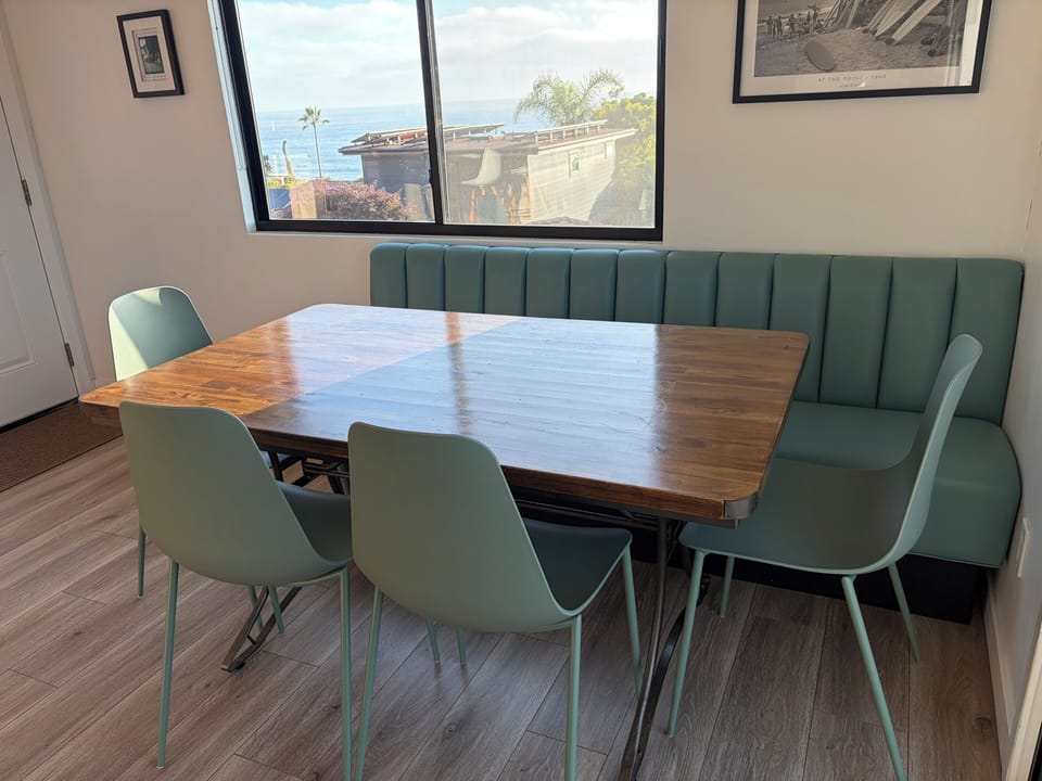 Dining area with view of ocean and built-in banquette