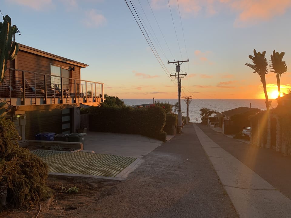 House to left with year round ocean and sunset views from upstairs balcony