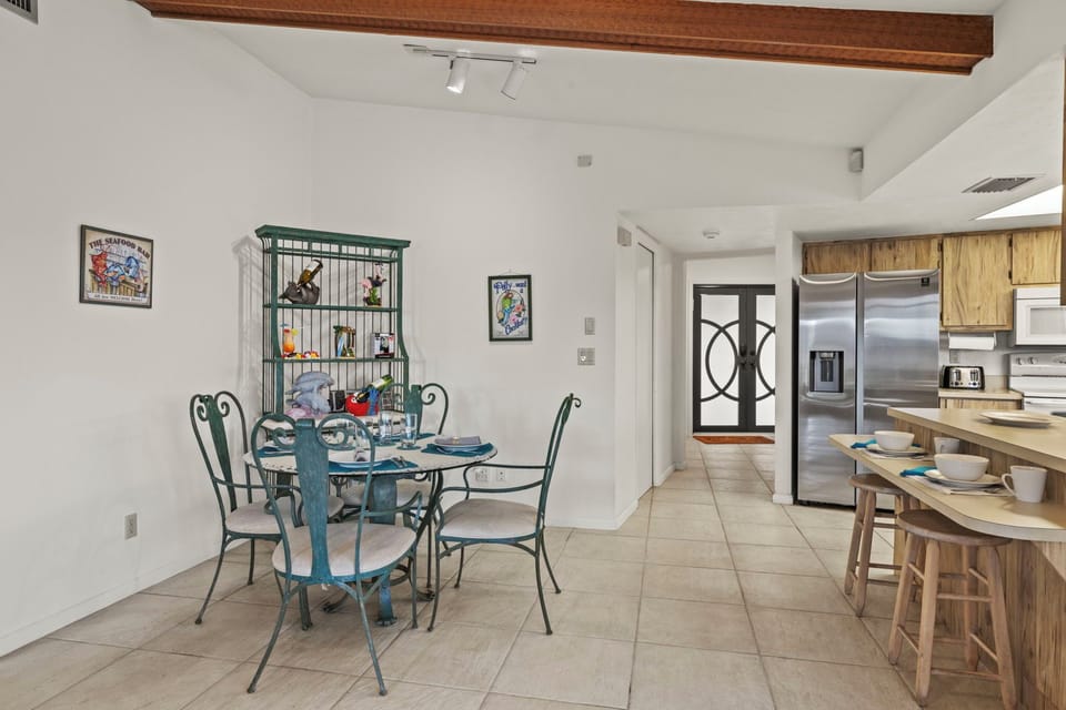 The dining area has room for 4 at the table & 2 more at the breakfast bar