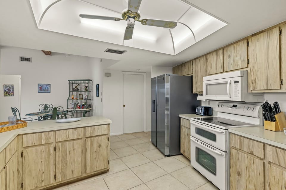 The kitchen features a new stainless steal fridge