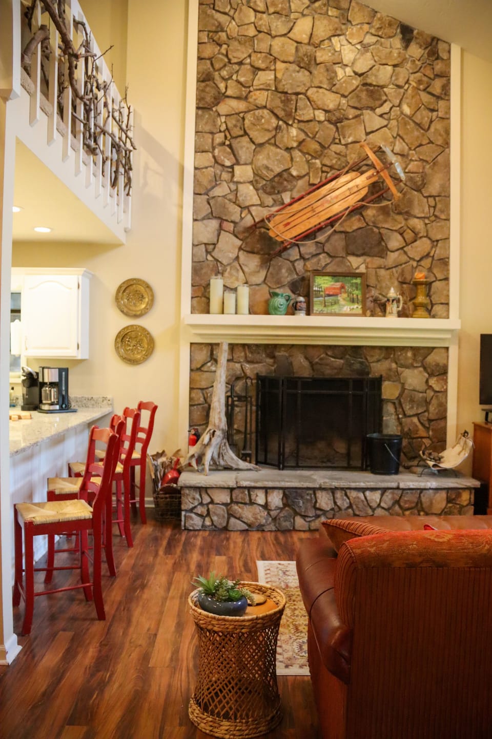 The two-story living room is anchored by the large stone wood-burning fireplace.