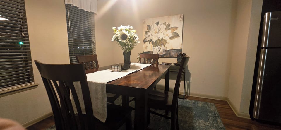 The dining room has chairs for four but there are two more chairs at the bar.