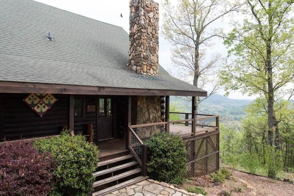 At the front of the home is a stone patio with gas grill, picnic table, fire pit and seating