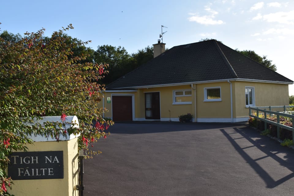 View of house from lane, with ample parking 