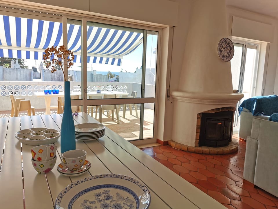 Dining Area with doors to sunny veranda and steps to pool area below