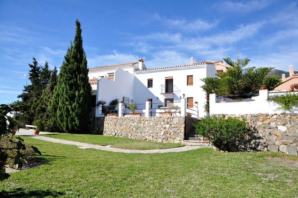 Front view of house with green area in the lower level