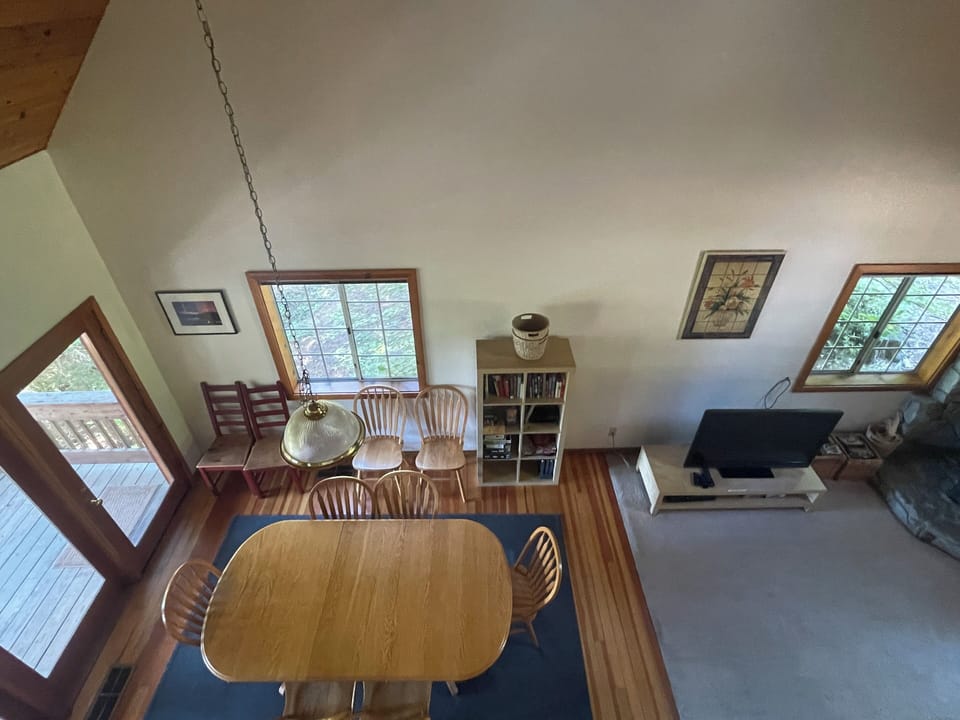 View of dining area and living room from loft