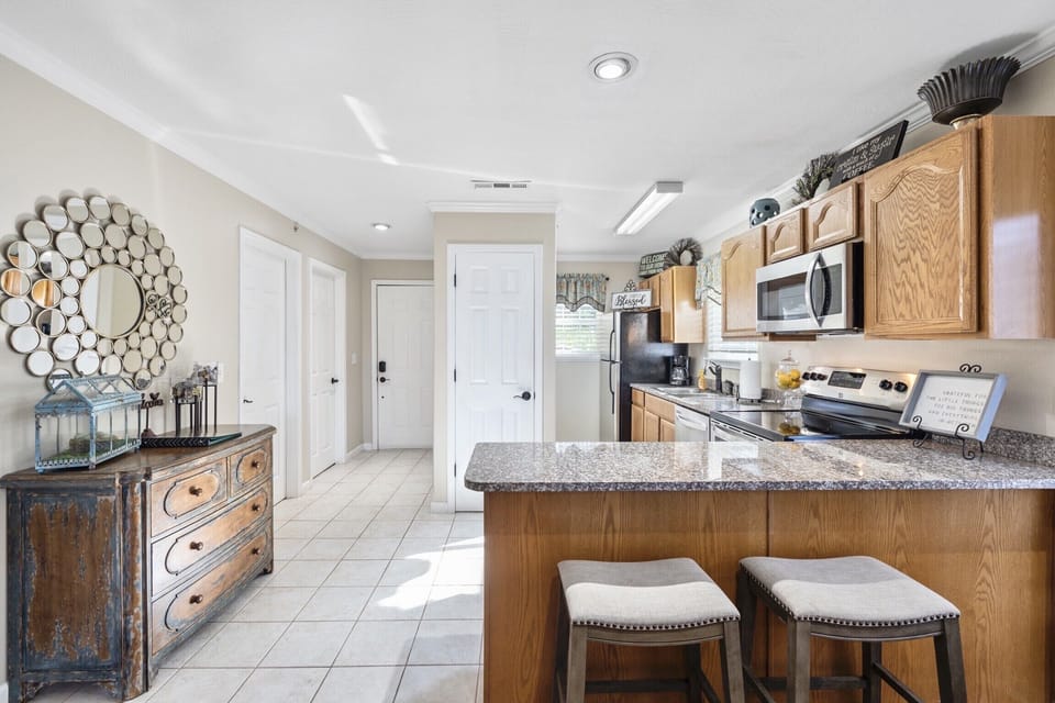 Fully stocked kitchen with stainless appliances and granite countertops