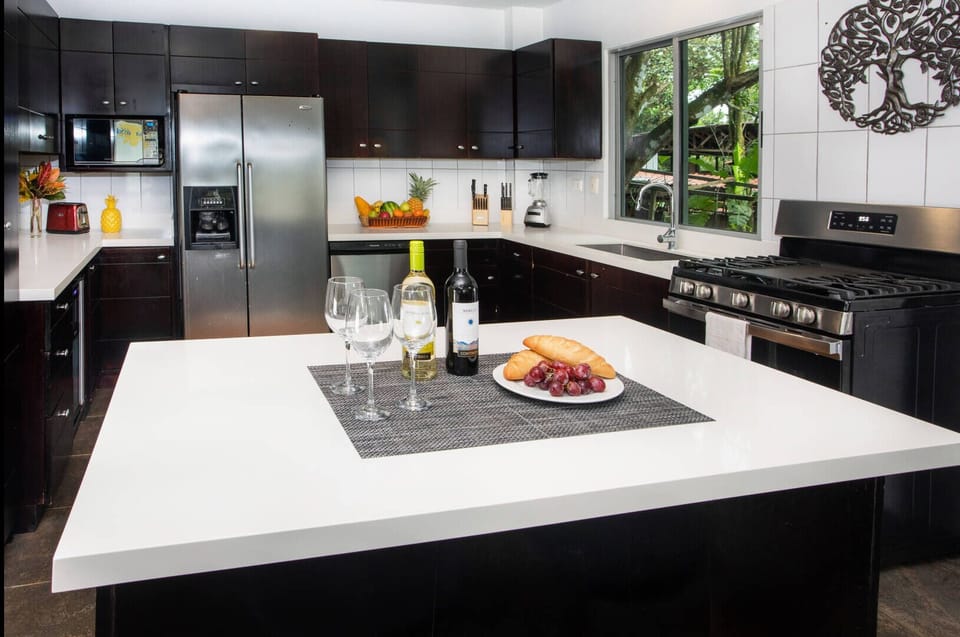 The gorgeous kitchen has modern high end appliances and new countertops. 