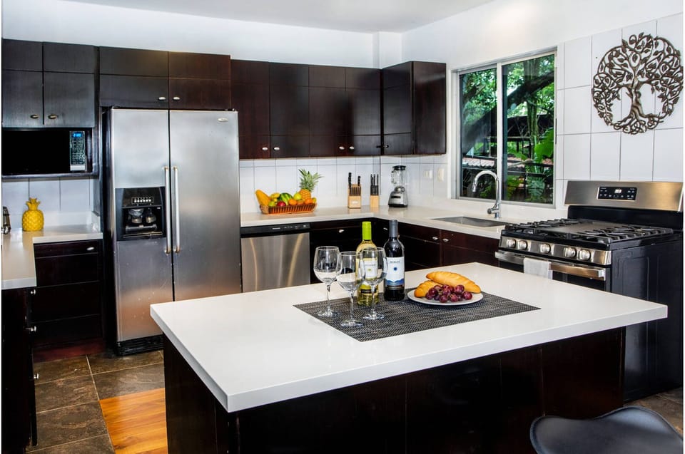 A modern kitchen with clean lines and plenty of workspace to prepare meals. 