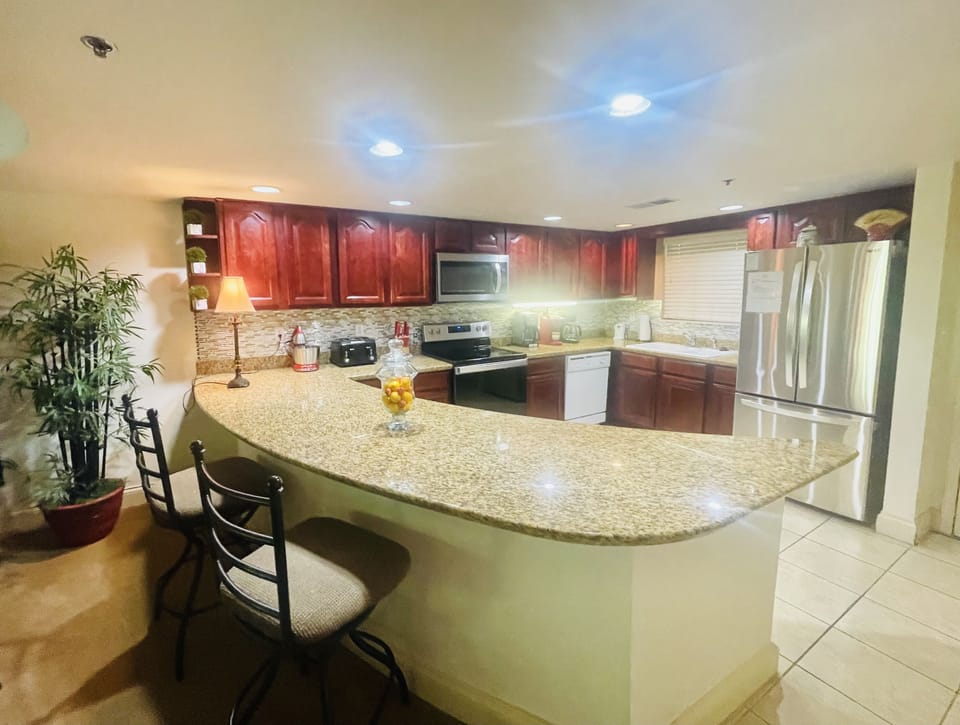 Kitchen with new stainless steel Refrigerator, stove and microwave 