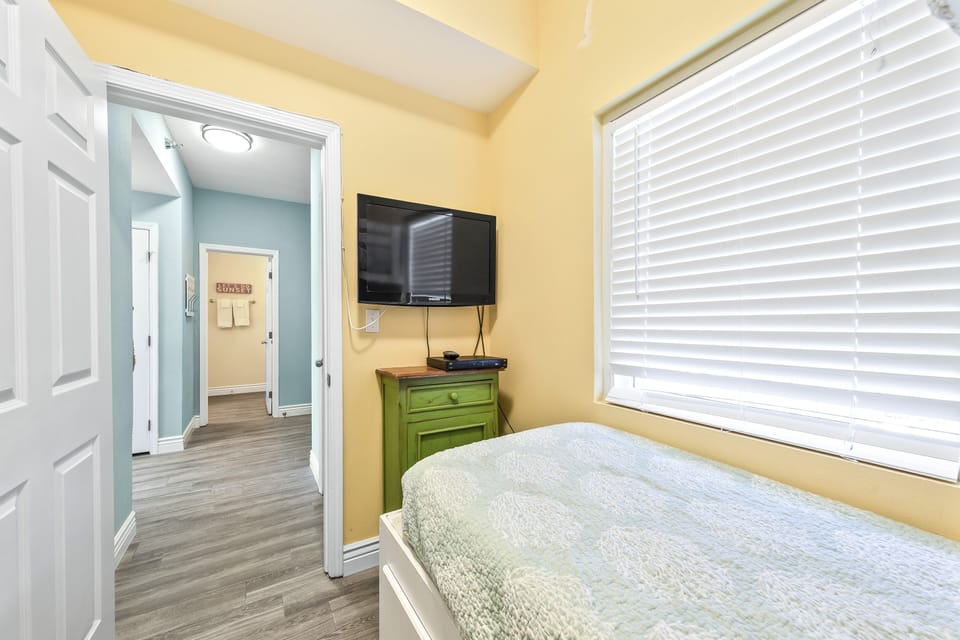 Bunk room with two twin beds, flat screen TV