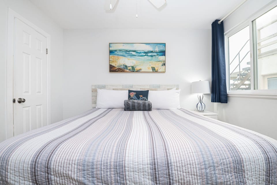 Clean lines, soothing hues, and inviting linens come together in this tranquil third bedroom
                