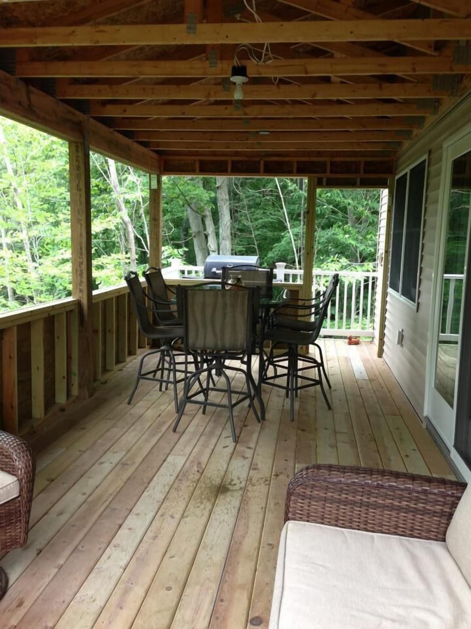 Covered patio located with gas grill is also wired with speakers/stereo