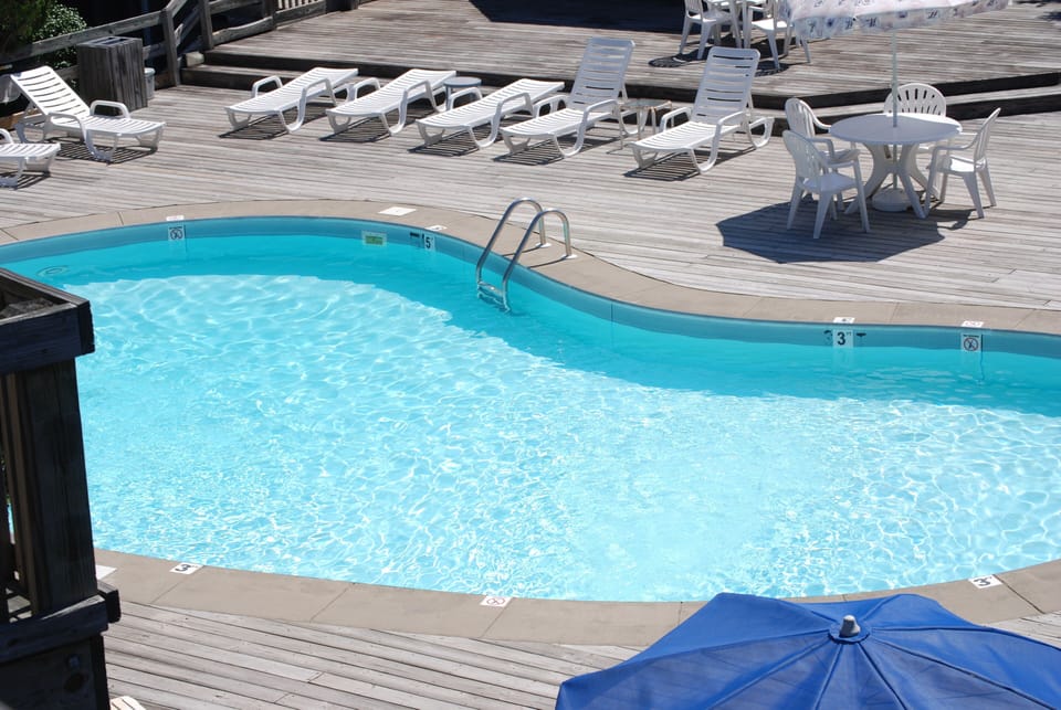 Close Up Pool View. There is a covered gazebo with picnic tables as well.