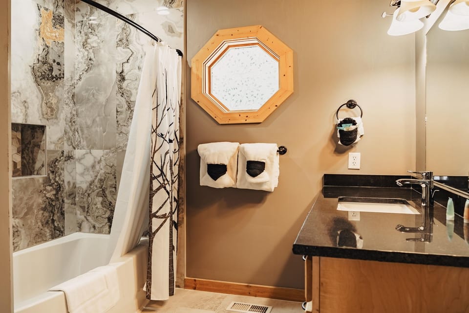Master bathroom includes curved bathtub for relaxing soaks.