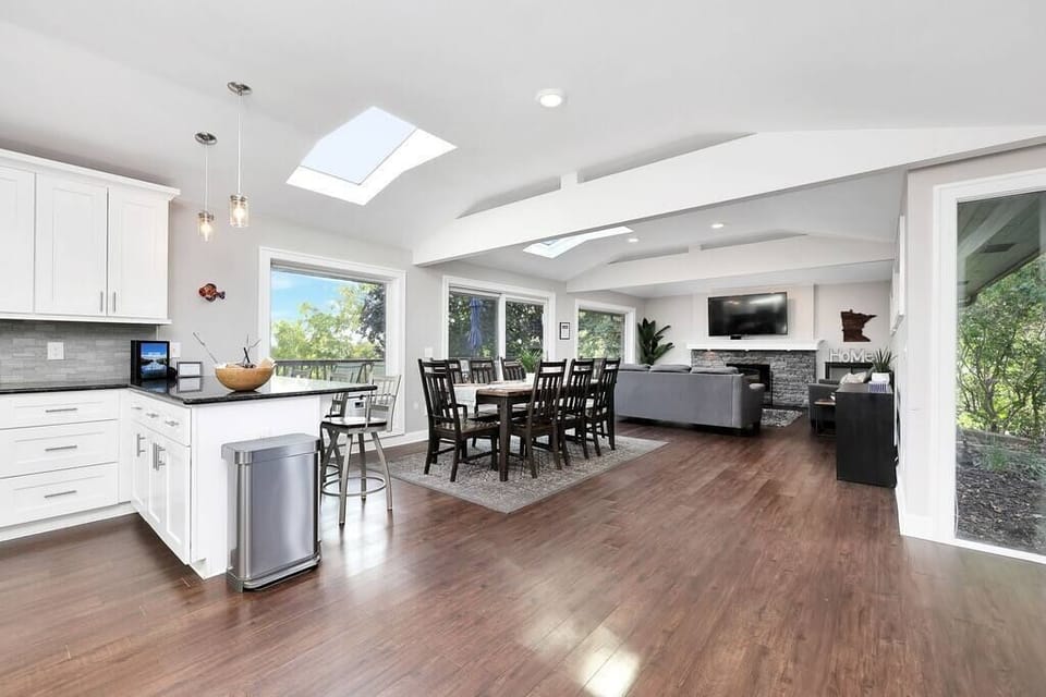 This home was designed with an open floor plan and large windows and skylights.  Main level living room, dining room and kitchen are connected to an enormous deck: the perfect layout for hosting an event or team outing.