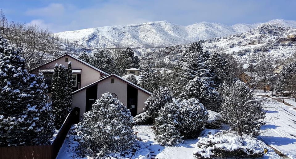 Our lovely home in winter -nestled in the pines in the foothills of the Rockies.