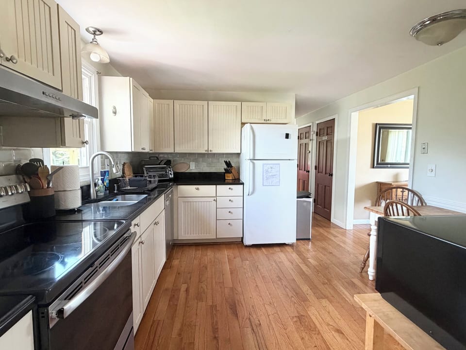 Fully stocked eat in Kitchen, pantry in hallway