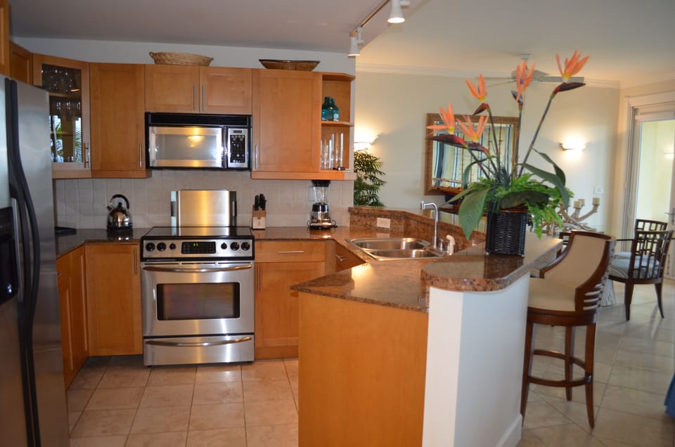 Spacious kitchen with granite counter tops and stainless steel appliances