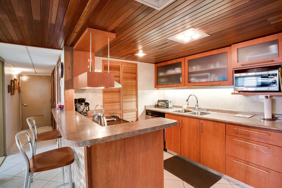 Kitchen features stainless steel dishwasher, stove, micro and fridge.