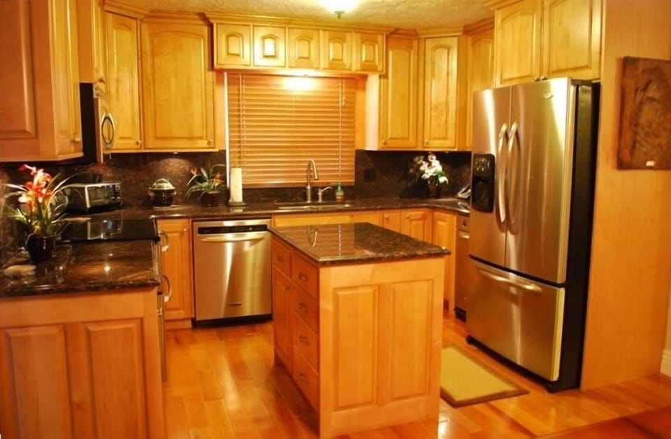 Kitchen with Granite Counter tops, Stainless Steel Appliances and Hardwood Floor