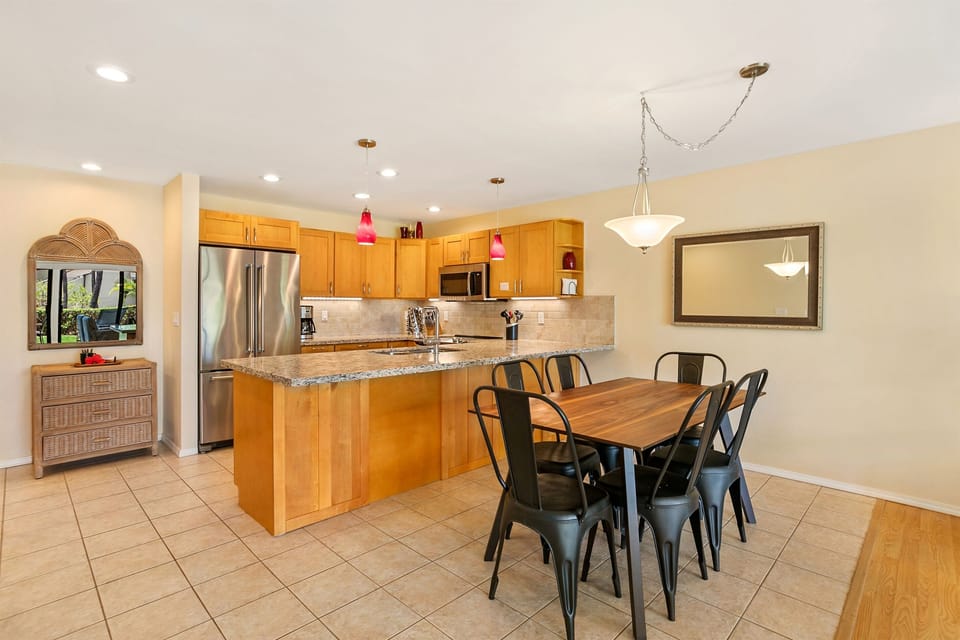 Another look at the kitchen and dining table - stainless appliances, spices, and a Vitamix!