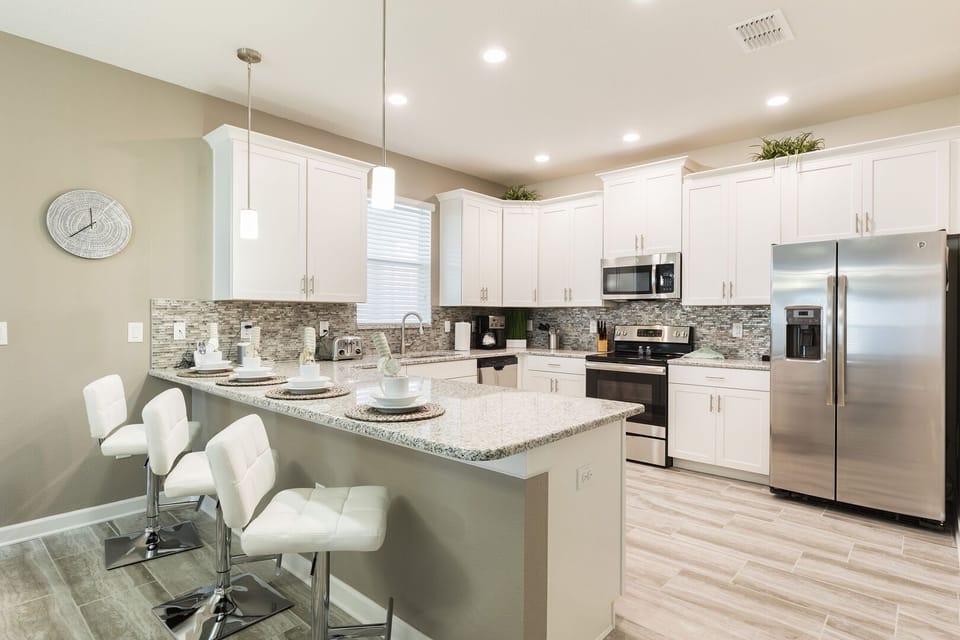 kitchen with  oven, refrigerator of luxuries villa at  The Retreat at ChampionsGate