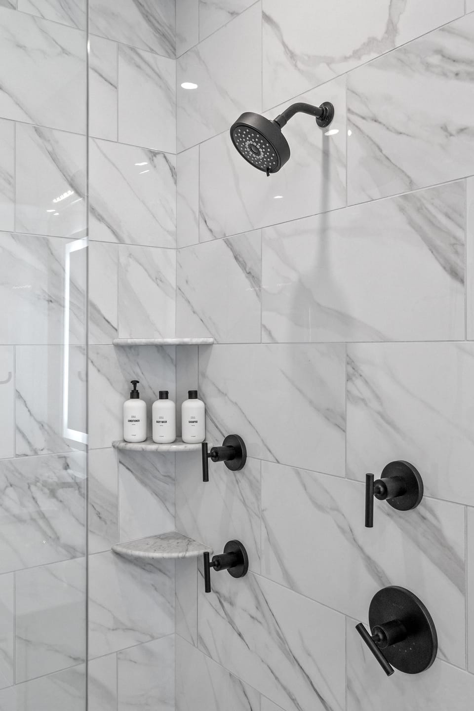 First floor master bathroom with dual vanities, heated floors, and walk in shower