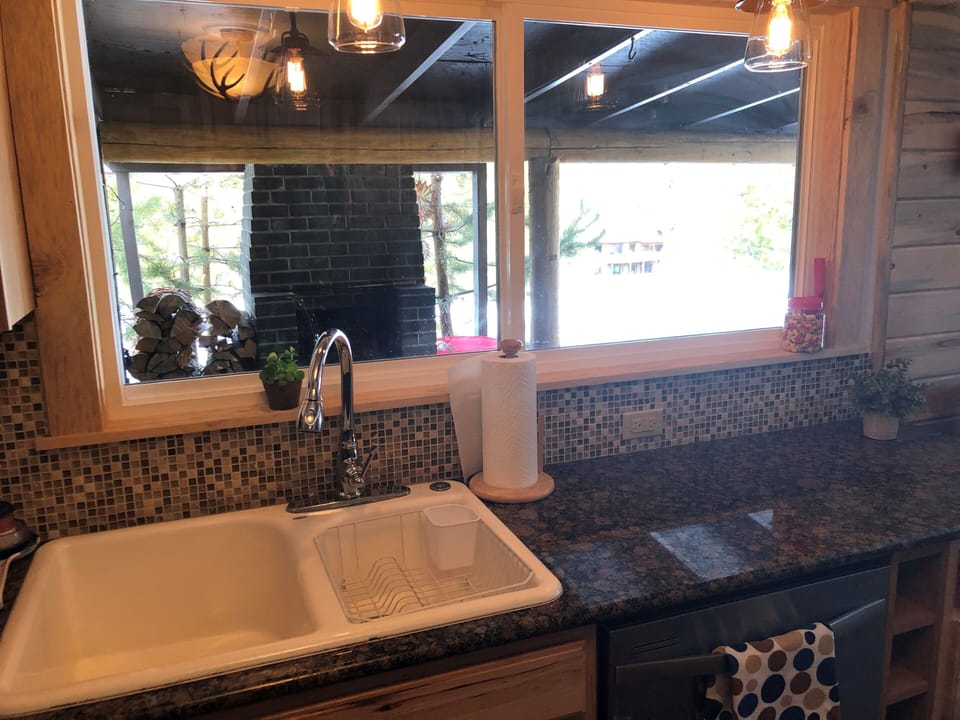 Kitchen with plenty of counter space and view of outside fireplace
